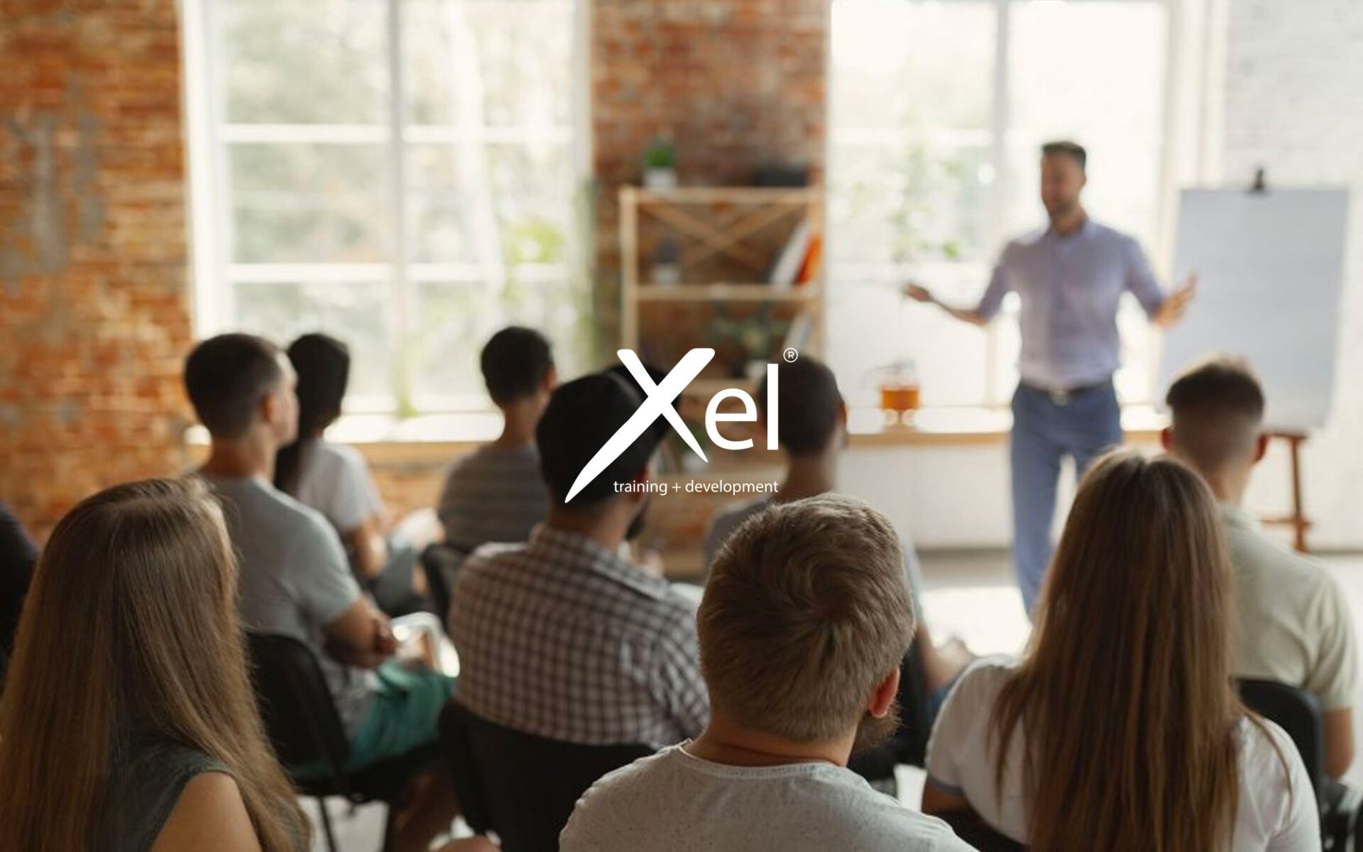 Audience listening to a speaker in a modern classroom setting